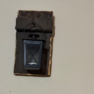 Black Wall Lantern Accent on Rustic Wood Backing